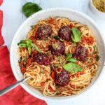 Vegan Spaghetti and Beetballs! A beautiful twist on the comforting familiar classic. Beets, black beans, walnuts and basil make these plant-based meatballs scrumptious and so satisfying. Top with an easy rustic tomato sauce for a meal the whole family will love! #vegan #veganmeatballs #beetballs #spaghetti #veganspaghetti