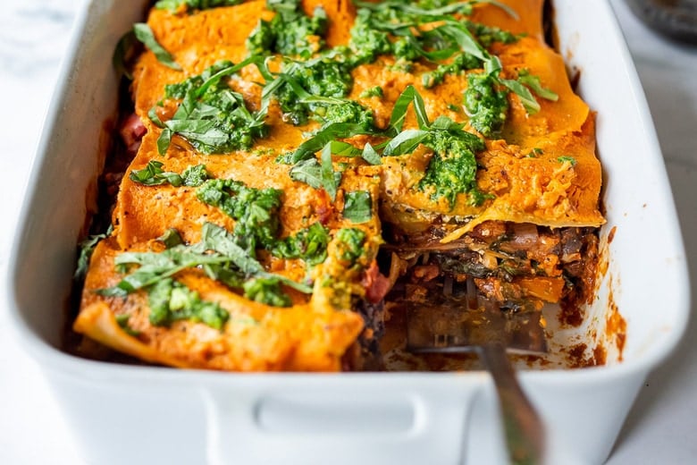 This Vegan Lasagna is made with a robust mushroom and spinach bolognese sauce, fresh basil, vegan ricotta and no-boil lasagna noodles, topped off with a creamy marinara sauce, drizzled with Arugula Pesto. Vegan comfort food at its tastiest! 