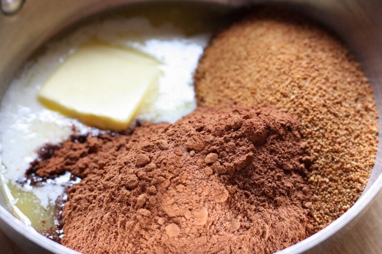 cocoa powder, butter and sugar melting in a sauce pan.