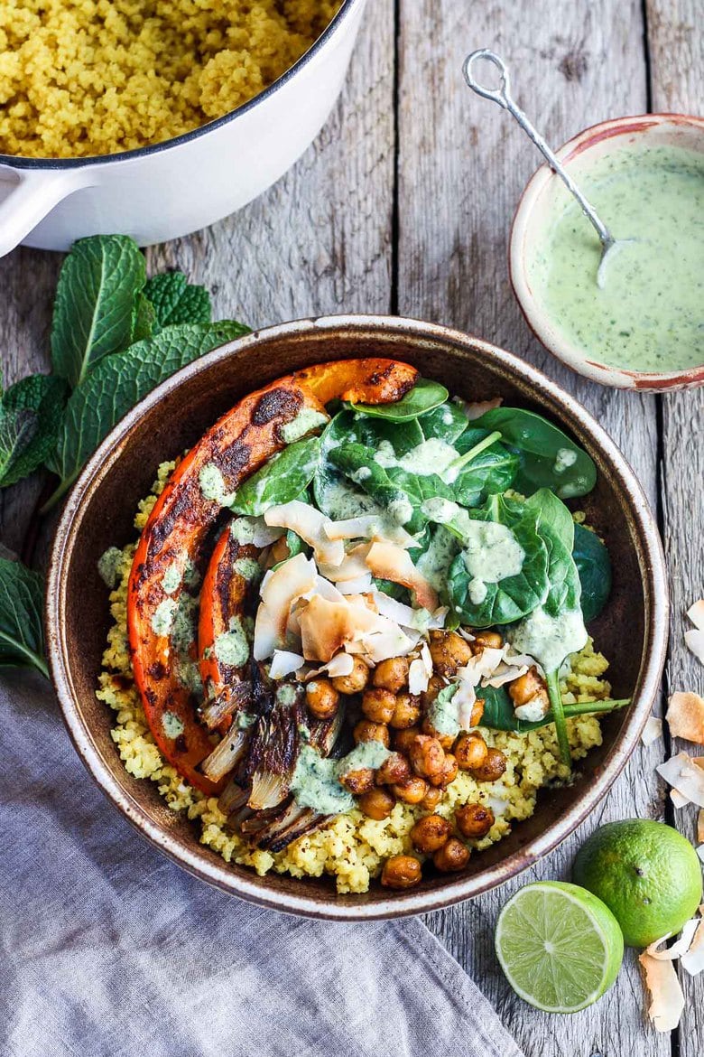 Coconut Millet Bowl with Berbere-Spiced Kabocha Squash, chickpeas, shallots, and spinach drizzled with coconut lime mint sauce.  A vegan, plant-based meal, full of vibrant flavor and spice. #millet #veganbowl #buddhabowl #berbere
