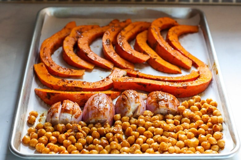 Liberally coat squash, shallots and chickpeas with the paste.  (You could easily add chicken breasts or thighs to the roast too!).  Give a sprinkling of salt and pop into the oven to roast.
