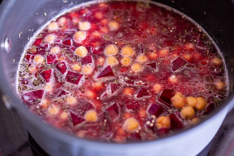 add quinoa, beets chickpeas, water salt and spices to the pot and stir, bring to a boil, cover.