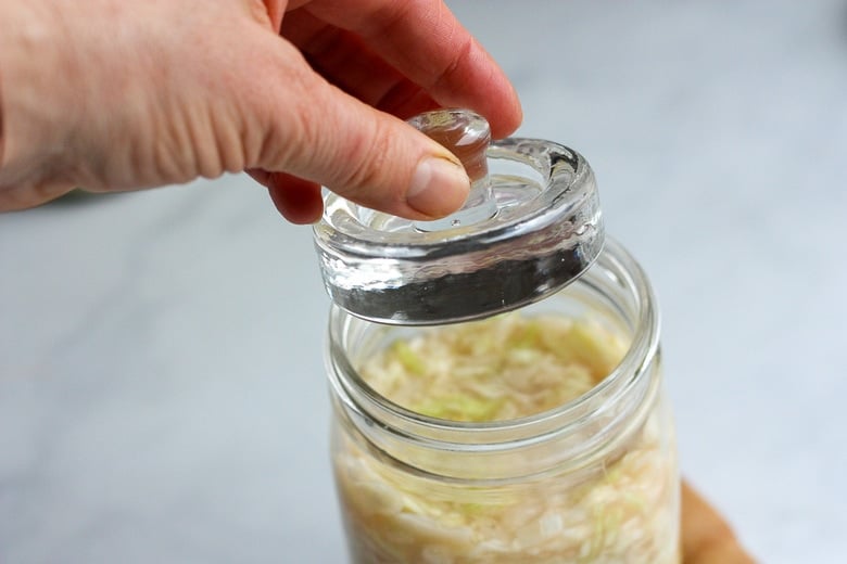 How to make Simple Cultured Cabbage!  Aka Sauerkraut- a delicious tangy addition to many dishes. Brimming with gut-healing probiotics, fermented cabbage is easy to make at home with just two ingredients!  