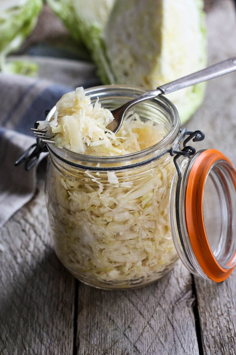 How to make Simple Cultured Cabbage!  Aka Sauerkraut- a delicious tangy addition to many dishes. Brimming with gut-healing probiotics, fermented cabbage is easy to make at home with just two ingredients!  