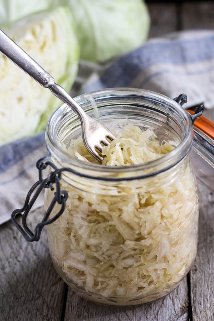 How to make Sauerkraut- a delicious tangy addition to many dishes.Brimming with gut-healing probiotics, cultured cabbage is easy to make at home with just two ingredients!  