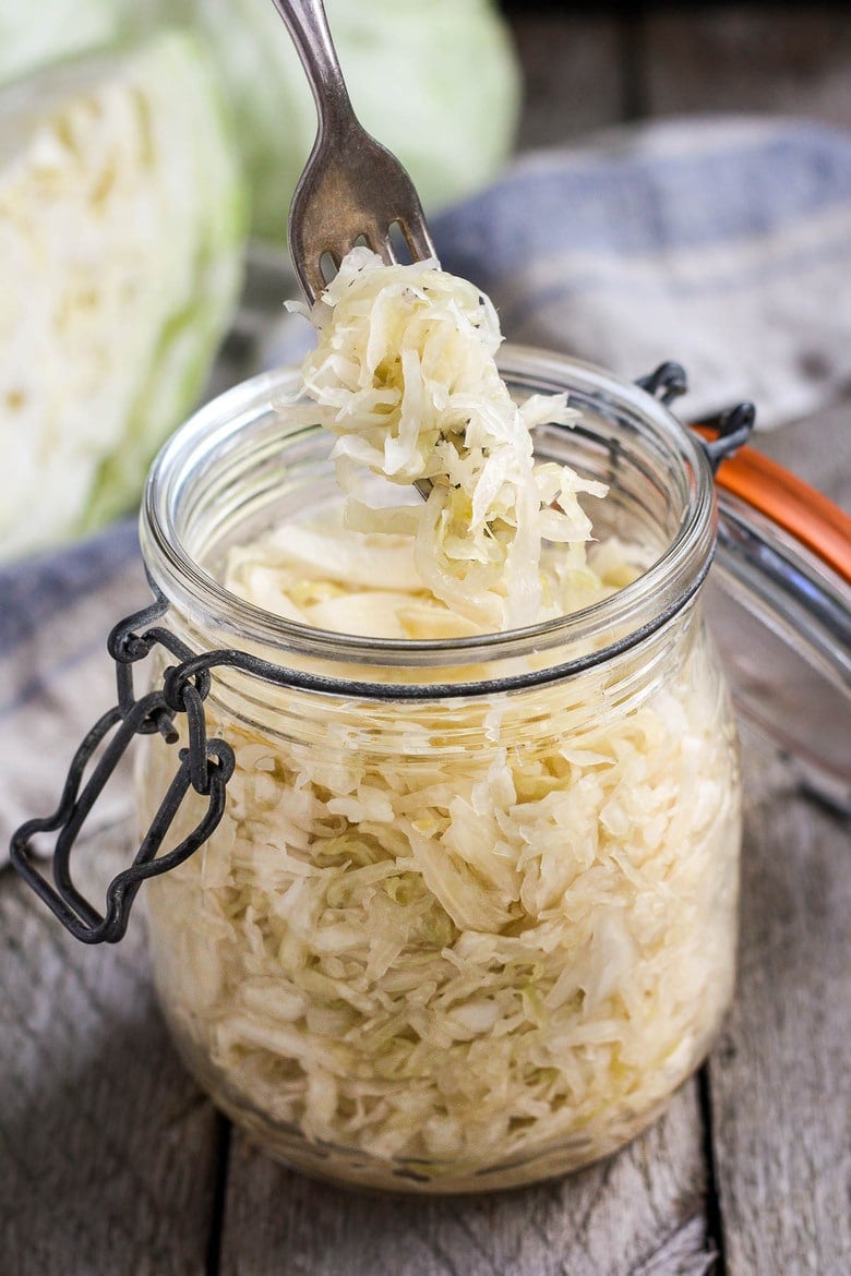 How to make Simple Cultured Cabbage!  Aka Sauerkraut- a delicious tangy addition to many dishes. Brimming with gut-healing probiotics, fermented cabbage is easy to make at home with just two ingredients!  