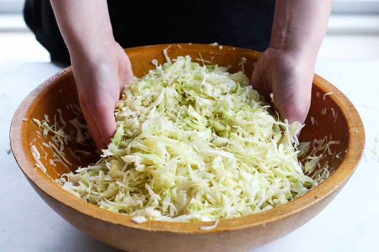 How to make Simple Cultured Cabbage!  Aka Sauerkraut- a delicious tangy addition to many dishes. Brimming with gut-healing probiotics, fermented cabbage is easy to make at home with just two ingredients!  