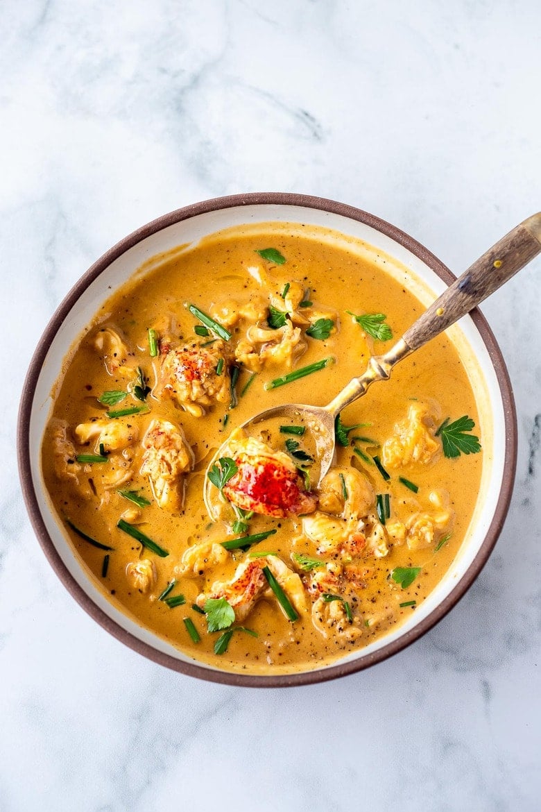 This Lobster Bisque Recipe is made simple and easy with quick homemade lobster stock, big bites of lobster, and a creamy luscious bisque thickened with sweet potatoes. For extra decadence saute the lobster in browned butter infused with garlic.