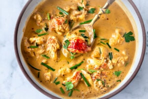 This Lobster Bisque Recipe is kept simple and easy with quick homemade lobster stock, big bites of lobster tail, and a creamy luscious bisque thickened with sweet potatoes. For Extra decadence the lobster is sautéed in browned butter. #lobsterbisque #lobster