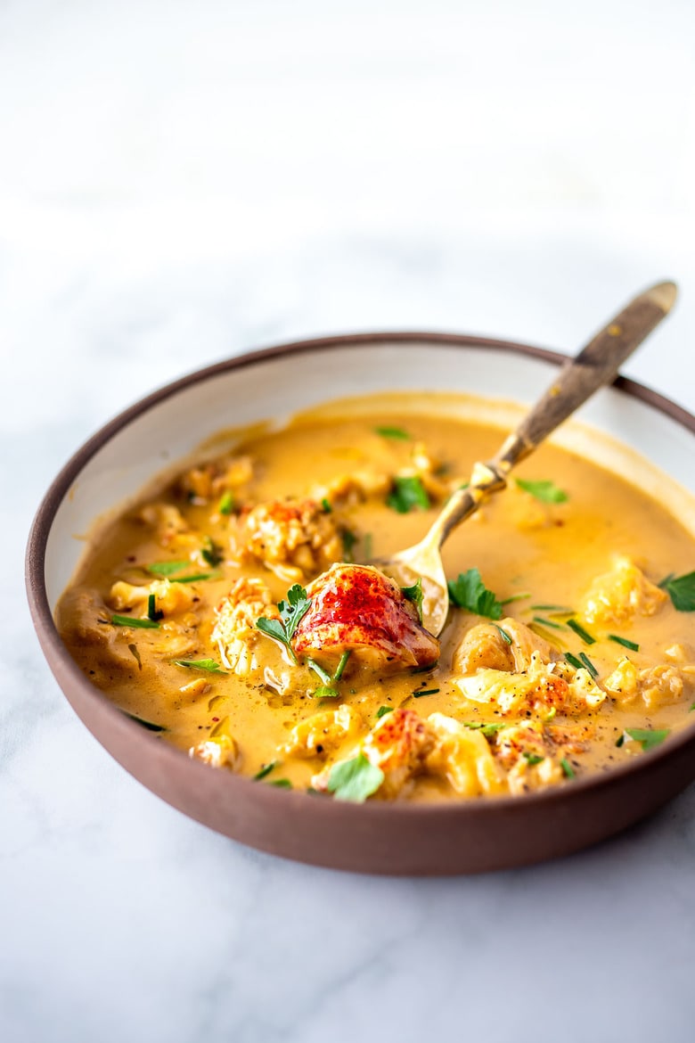This Lobster Bisque Recipe is made simple and easy with quick homemade lobster stock, big bites of lobster, and a creamy luscious bisque thickened with sweet potatoes. For extra decadence saute the lobster in browned butter infused with garlic.