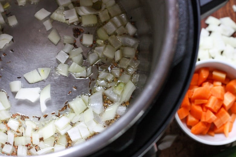 Use the saute function in the instant pot to saute onion and whole seeds