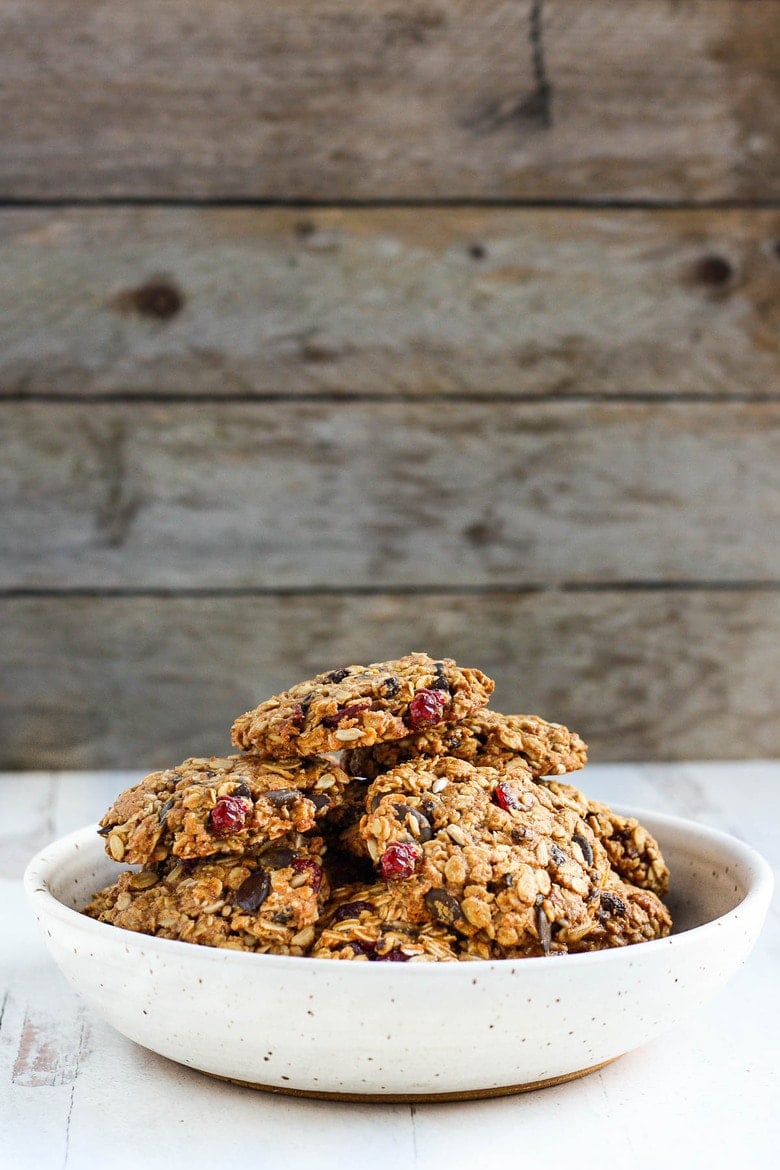 These healthy Breakfast Cookies can be made in under 30 minutes! They are chockfull of flavor and sustenance -filled with oats, seeds, spices and dried fruit they are vegan and deliciously addicting! Perfect for breakfast on the go. #breakfastcookie