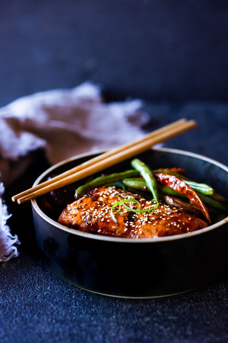 A tasty recipe for Sheet-Pan Szechuan Salmon with Scallion Green Beans baked in the oven that can be made in 30 minutes. A delicious healthy weeknight dinner! #szechuan #salmon #sheetpandinner 