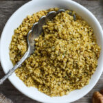 Vegan Cheesy Sprinkles! Give a little savory depth to your meals with this dairy-free rich topping. Perfect for pasta dishes, soups, and salads- a great vegan substitute for parmesan cheese. Easy to make in less than 20 minutes! #veganparmesan