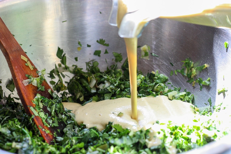 pour the batter into the herbs and veggies