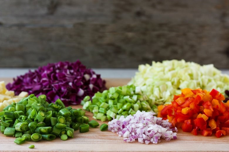 Prepped veggies in chopped salad. 