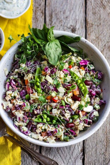 This Rainbow Chopped Salad is crunchy, colorful and nutritious! Tossed with a lemony herbed greek yogurt dressing, it is easy to make and easy to adapt. Perfect for meal prep, this salad keeps for 4 days in the fridge.