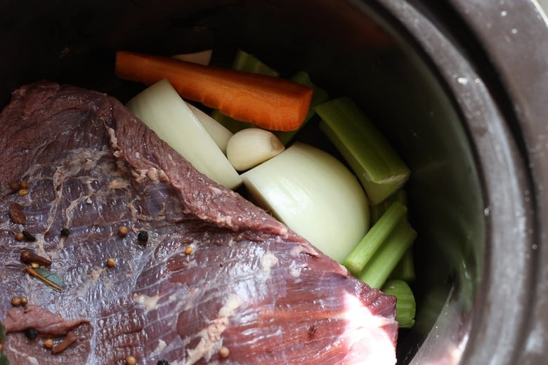 Rinse the meat and cook in the slow cooker until tender