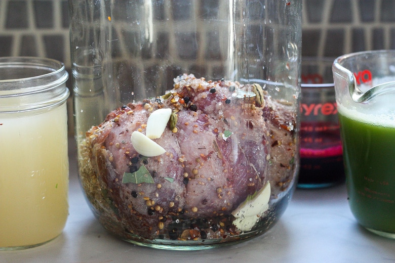 place the rolled meat in a large jar with garlic cloves