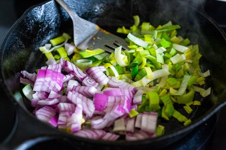 Onions and leeks in cast iron pan.