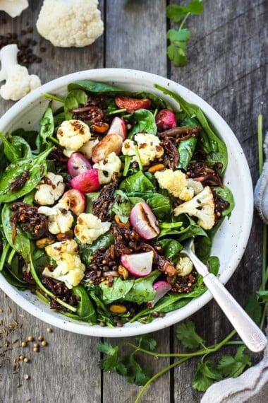 This Indian spinach salad is loaded with black lentils, roasted cauliflower, and bold flavor from a crunchy tempered seed dressing—fresh, hearty, and incredibly satisfying. 