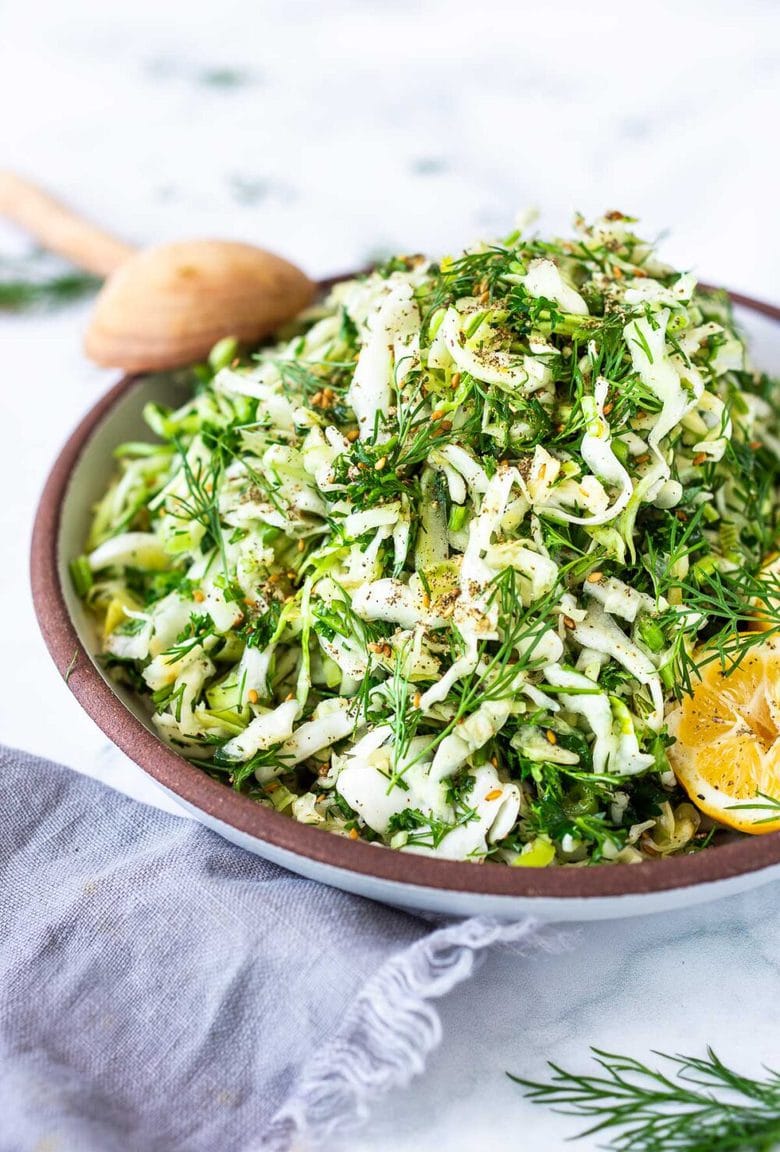 Simple Lebanese Slaw (aka Salatet Malfouf) made with crunchy cabbage, fresh herbs, lemon, garlic and scallions. A delicious vegan side to serve with your Middle Eastern feast. #slaw