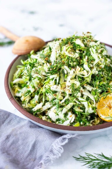 Simple Lebanese Slaw (aka Salatet Malfouf) made with crunchy cabbage, fresh herbs, lemon, garlic and scallions. A delicious vegan side to serve with your Middle Eastern feast. #slaw