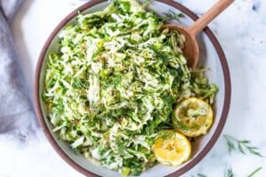 Simple Lebanese Slaw made with crunchy cabbage, fresh herbs, lemon, garlic and scallions. A delicious vegan side to serve with your Middle Eastern feast. #slaw