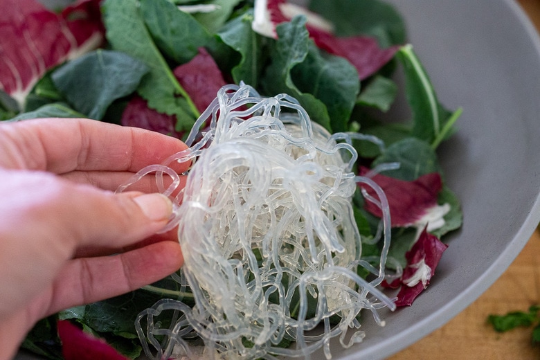 layering the salad with kelp noodles 