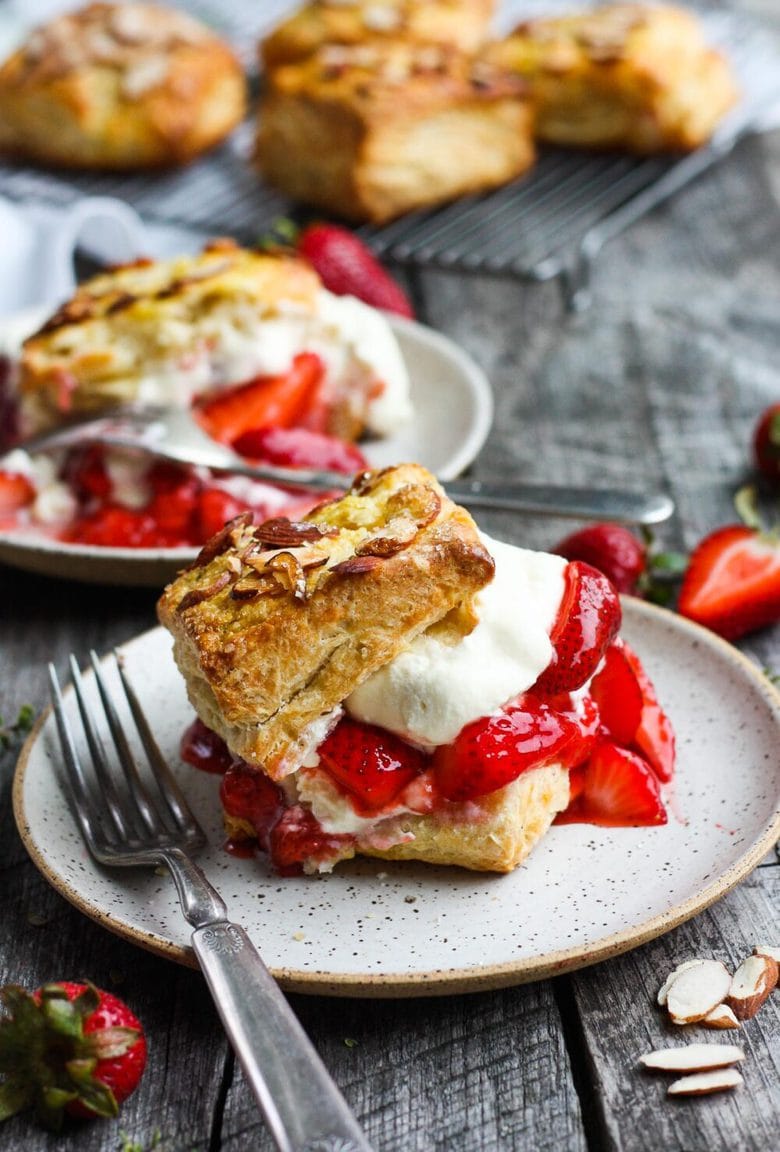 Homemade Strawberry Shortcake from Scratch with golden, flakey biscuits, jammy strawberry sauce, and yogurt whip cream.  The perfect American dessert with a twist.  This elevated version of the classic is subtly sweet and deeply satisfying. #strawberryshortcake