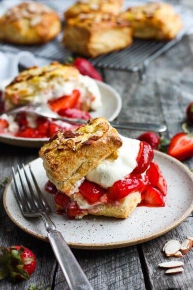 Homemade Strawberry Shortcake from Scratch with golden, flakey biscuits, jammy strawberry sauce, and yogurt whip cream.  The perfect American dessert with a twist.  This elevated version of the classic is subtly sweet and deeply satisfying. #strawberryshortcake