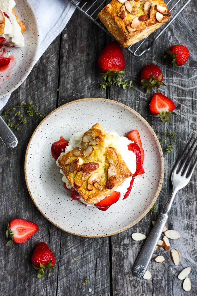 Luscious Strawberry Shortcake with golden flakey biscuits, jammy strawberry sauce, and yogurt whip cream.  The perfect American dessert with a twist.  This elevated version of the classic is subtly sweet and deeply satisfying. #strawberryshortcake 