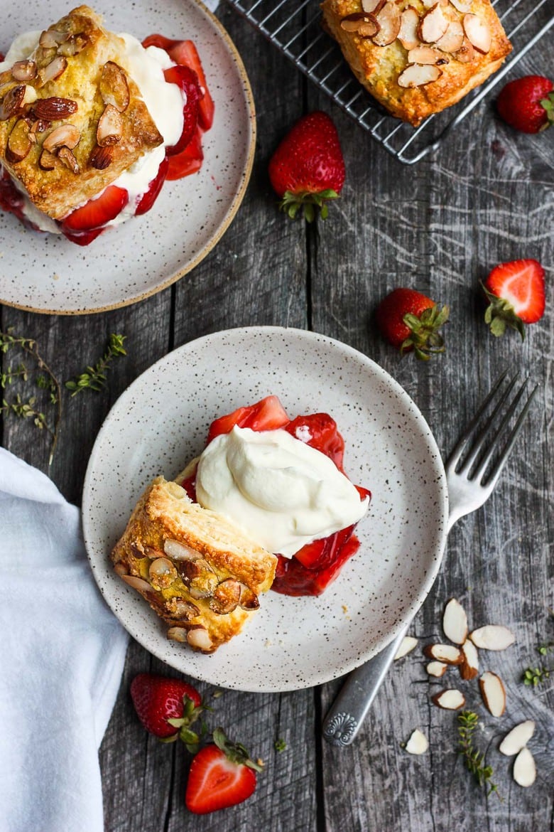 Luscious Strawberry Shortcake with golden flakey biscuits, jammy strawberry sauce, and yogurt whip cream.  The perfect American dessert with a twist.  This elevated version of the classic is subtly sweet and deeply satisfying. #strawberryshortcake 