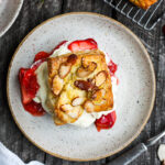 Homemade Strawberry Shortcake from Scratch with golden, flakey biscuits, jammy strawberry sauce, and yogurt whip cream. The perfect American dessert with a twist. This elevated version of the classic is subtly sweet and deeply satisfying. #strawberryshortcake
