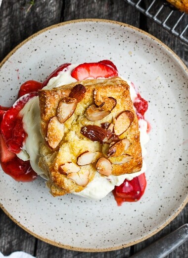 Homemade Strawberry Shortcake from Scratch with golden, flakey biscuits, jammy strawberry sauce, and yogurt whip cream.  The perfect American dessert with a twist.  This elevated version of the classic is subtly sweet and deeply satisfying. #strawberryshortcake