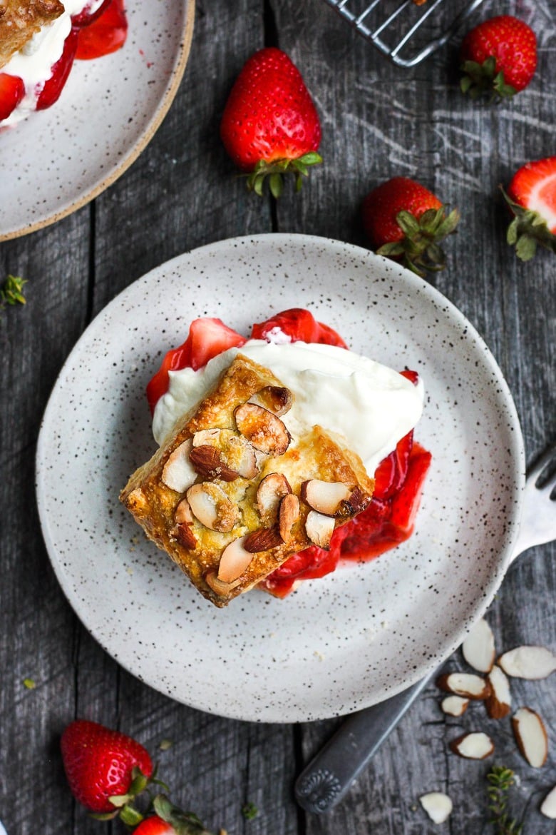 Luscious Strawberry Shortcake with golden flakey biscuits, jammy strawberry sauce, and yogurt whip cream.  The perfect American dessert with a twist.  This elevated version of the classic is subtly sweet and deeply satisfying. #strawberryshortcake 