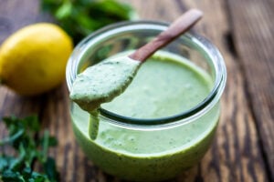 Green Tahini Sauce made with tahini paste, fresh herbs, garlic, lemon and a few slices of green chilies. Perfect with falafels, shawarma, mezze platters!
