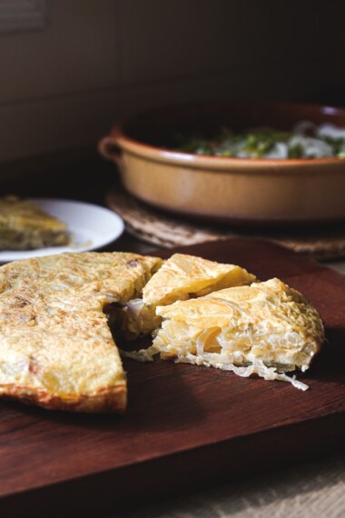 This classic Spanish Potato Tortilla (aka Tortilla de Patatas or Torta Espanola) is a lightened-up version made with thinly sliced potatoes, caramelized onions, eggs, and olive oil that can be served for tapas, breakfast, lunch or dinner. #spanishtortilla #tortilladepatatas #tortaespanola