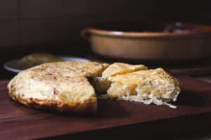 This classic Spanish Potato Tortilla (aka Tortilla de Patatas or Torta Espanola) is a lightened-up version made with thinly sliced potatoes, caramelized onions, eggs, and olive oil that can be served for tapas, breakfast, lunch or dinner. #spanishtortilla #tortilladepatatas #tortaespanola