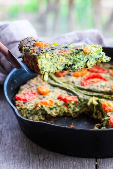 This Vegan Frittata recipe celebrates the flourishing greenness of springtime. Stocked up with fresh herbs, leeks, asparagus, and a creamy chickpea flour filling, it's delicious!