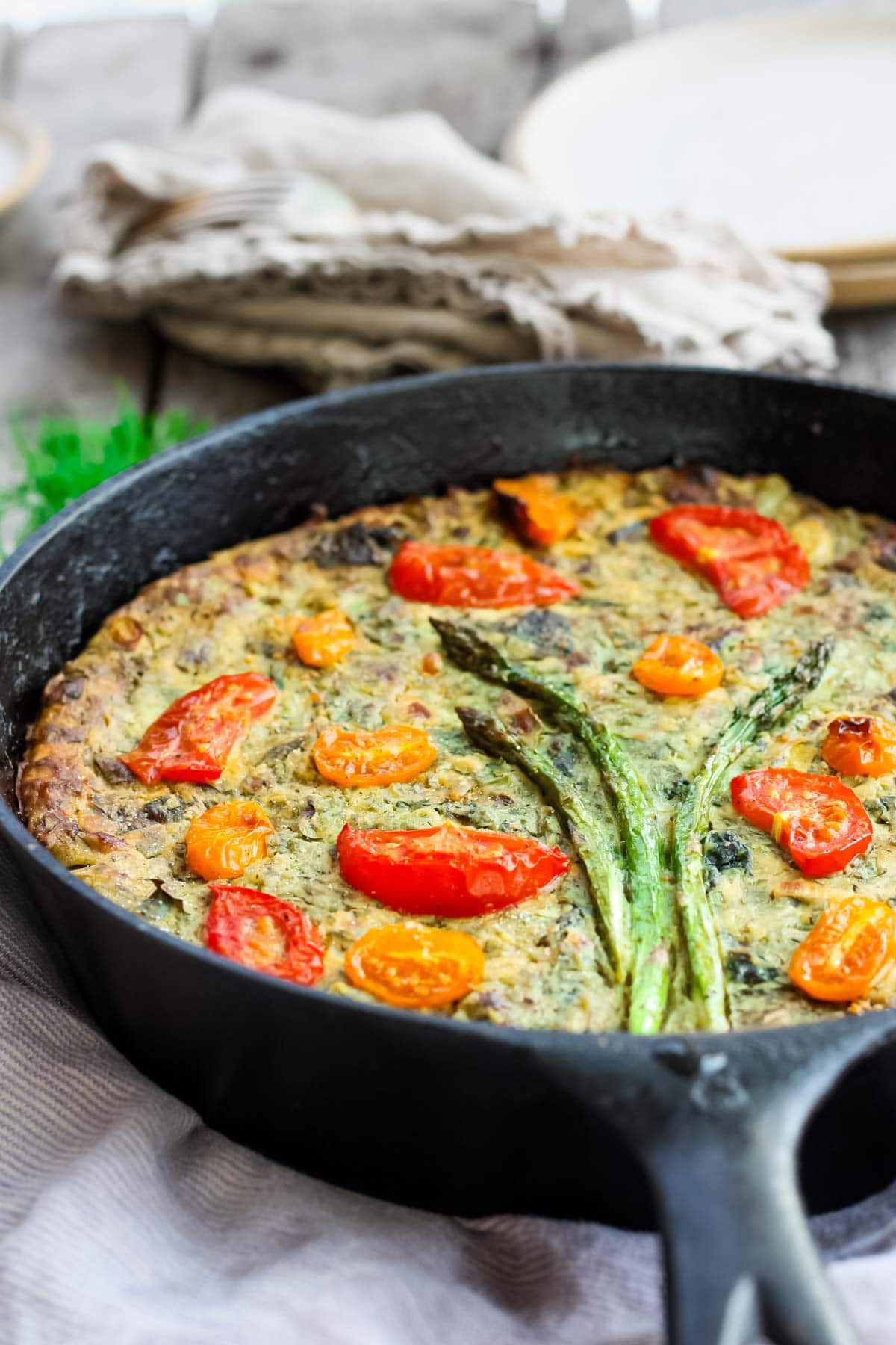 This Vegan Frittata recipe celebrates the flourishing greenness of springtime. Stocked up with fresh herbs, leeks, asparagus, and a creamy chickpea flour filling, it's delicious!This Vegan Frittata recipe celebrates the flourishing greenness of springtime. Stocked up with fresh herbs, leeks, asparagus, and a creamy chickpea flour filling, it's delicious!