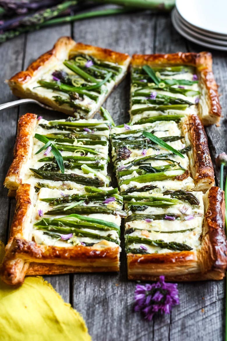 asparagus tart cut into squares with a flaky puff pastry crust.