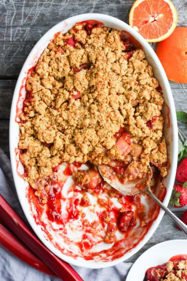 This Strawberry Rhubarb Cobbler is bursting with sweet strawberries, tangy rhubarb, fresh orange, and crystallized ginger, all topped with a rustic masa flour corn crust. A delicious summer dessert that's equally perfect for brunch.