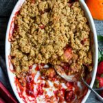A scrumptious Strawberry Rhubarb Cobbler is infused with ginger and orange zest and topped with a golden corn flour crust. #strawberrycrumble #strawberrycobbler