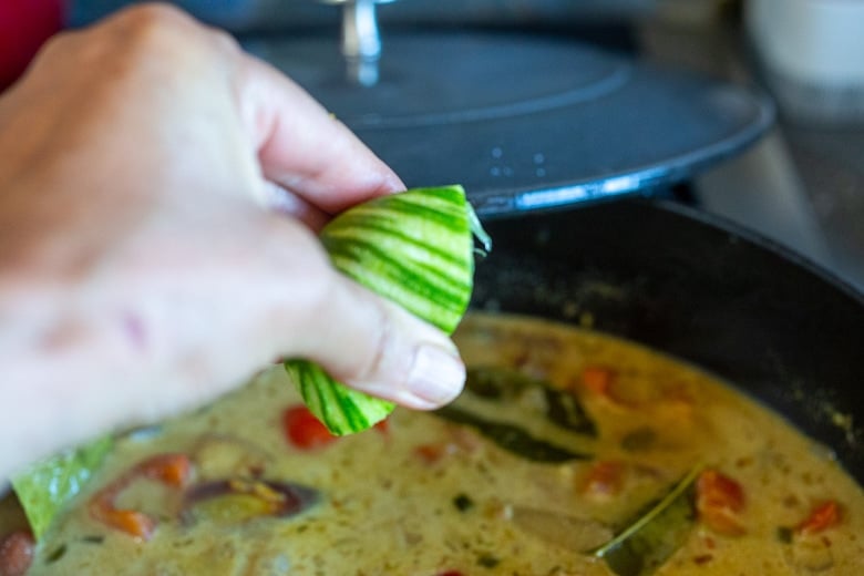 squeezing lime juice into the coconut curry. 