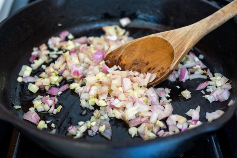 Sauteed shallot and garlic for creamy pea pasta.