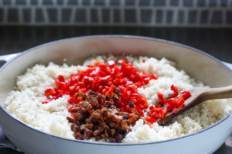 add diced red bell pepper and dried apricots to cauliflower mixture.