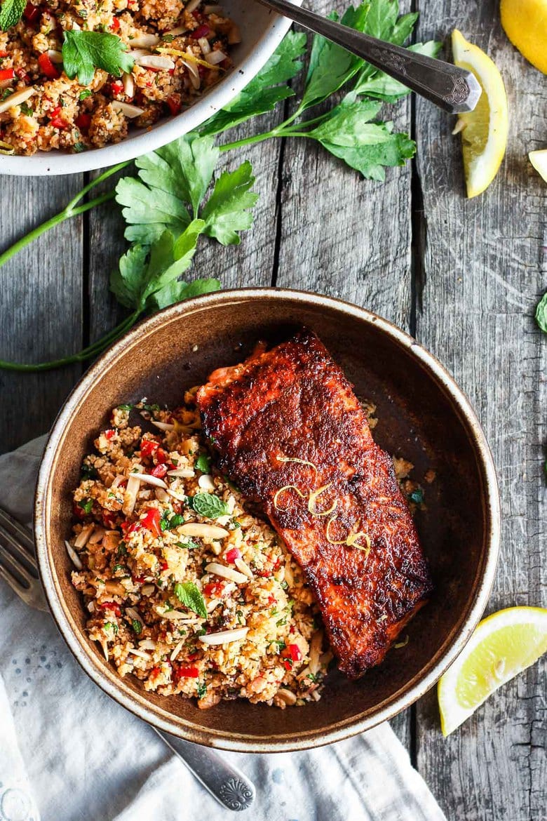 Moroccan Cauliflower "Couscous" made with riced cauliflower, dried apricots, toasted almonds and fragrant Moroccan spices, tossed with fresh parsley, mint and a lemon honey drizzle.   Gluten-free, healthy and vibrantly flavorful! Vegan-adaptable. #cauliflower #cauliflowerrice #couscous