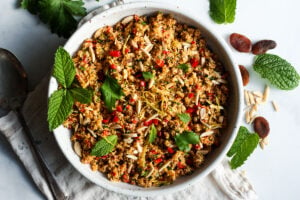 Moroccan Cauliflower "Couscous" made with riced cauliflower, dried apricots, toasted almonds and fragrant Moroccan spices, tossed with fresh parsley, mint and a lemon honey drizzle.   Gluten-free, healthy and vibrantly flavorful! Vegan-adaptable. #cauliflower #cauliflowerrice #couscous