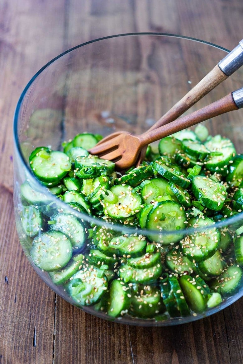 Asian Cucumber Salad made with rice vinegar, sesame, ginger, garlic and soy is cool and refreshing and pairs well with many things. It's vegan and gluten-free and is a nice addition to meals and bowls you are already making! #cucumbersalad 